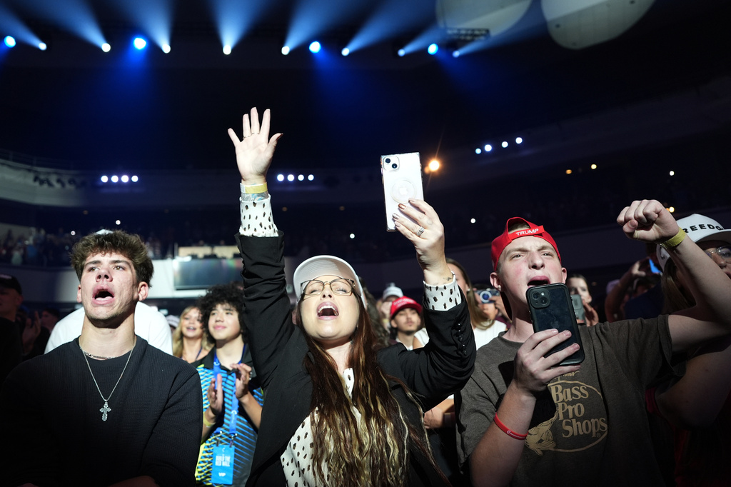People react as President Donald Trump speaks at a Turning Point USA event at Dream City Church, Friday, April 17, 2026, in Phoenix. (AP Photo/Alex Brandon)