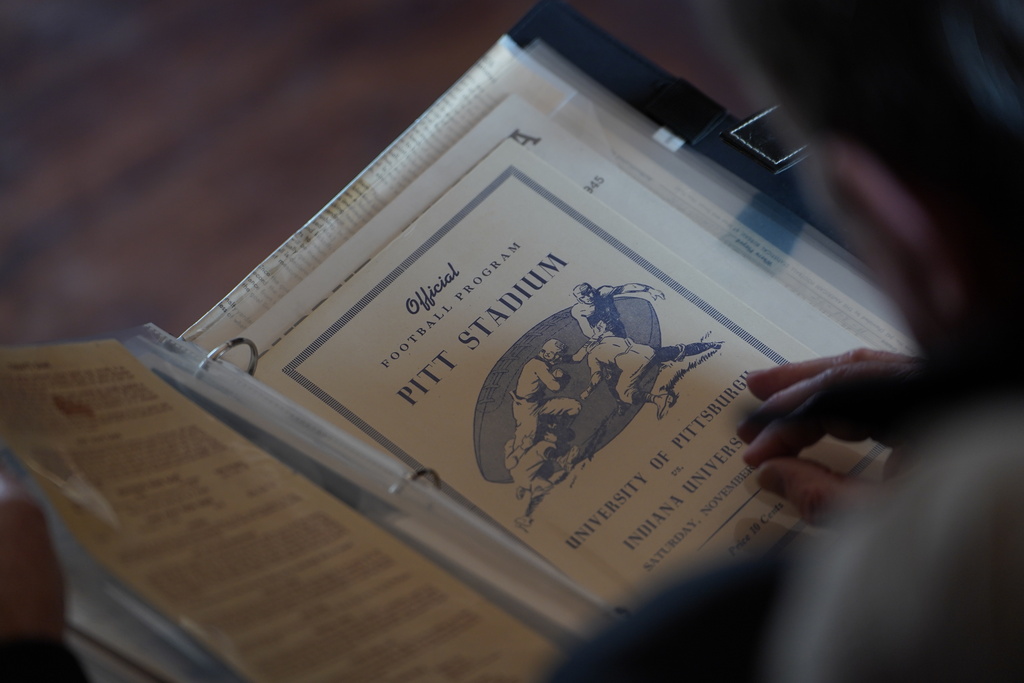 A vintage sports program sits in a photo album collected by Bill Murphy, 77, an Indiana football fan, at his home in Greenfield, Ind., Wednesday Dec. 17, 2025. (AP Photo/Obed Lamy)
