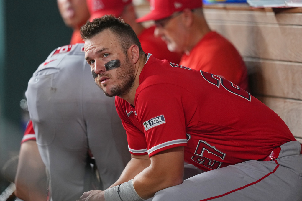 Los Angeles Angels designated hitter Mike Trout looks on from the dugout during the ninth inning of a baseball game against the Texas Rangers, Wednesday, July 8, 2026, in Arlington, Texas. (AP Photo/Julio Cortez)