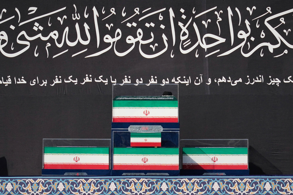 The coffins of the late Iranian Supreme Leader Ayatollah Ali Khamenei and members of his family are displayed on a platform at the start of the dayslong funeral ceremonies at the Imam Khomeini Mosalla Grand Mosque in Tehran, Iran, Saturday, July 4, 2026. (AP Photo/Altaf Qadri)