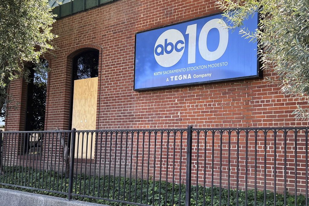 A boarded up window at the ABC10 building in Sacramento, Calif. is shown on Monday, Sept. 22, 2025, days after someone fired shots at the building. (AP Photo/Sophie Austin)