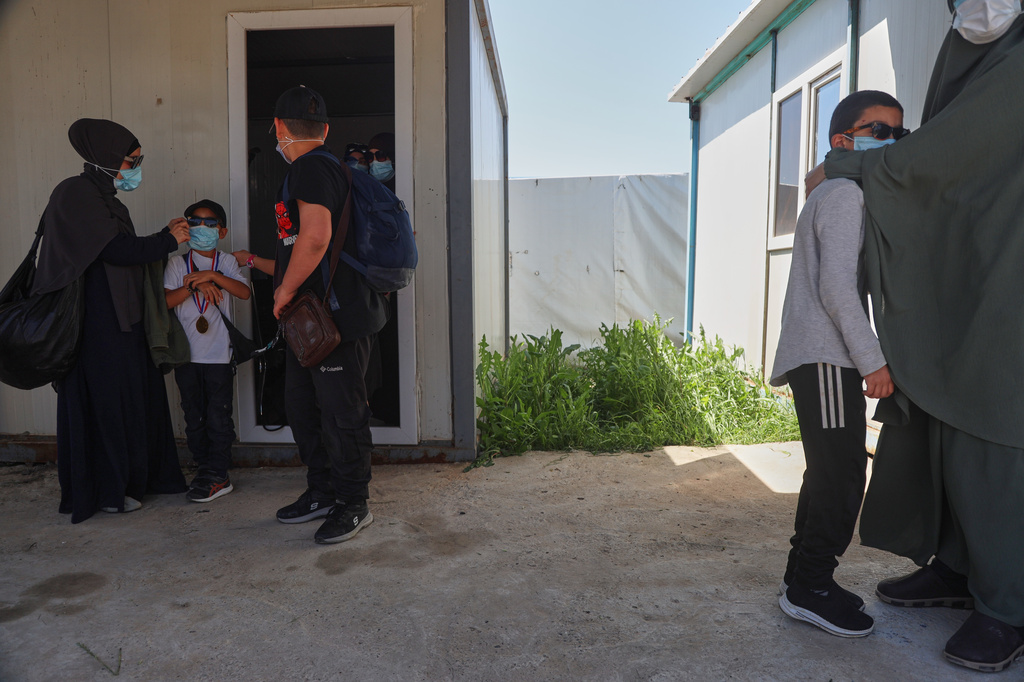 Members of Australian families at Roj Camp in eastern Syria, housing people with alleged ties to Islamic State militants, prepare to leave for Damascus as part of a second repatriation effort by Syrian authorities, Friday, April 24, 2026. (AP Photo/Baderkhan Ahmad)
