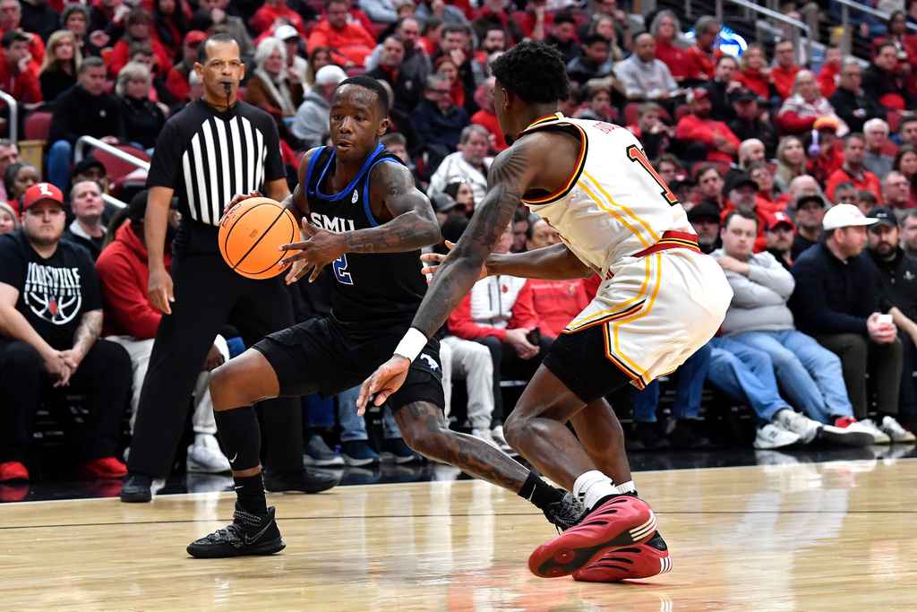 SMU guard Boopie Miller (2) attempts to drive past Louisville guard Kobe Rodgers (11) during the first half of an NCAA college basketball game in Louisville, Ky., Saturday, Jan. 31, 2026. (AP Photo/Timothy D. Easley)