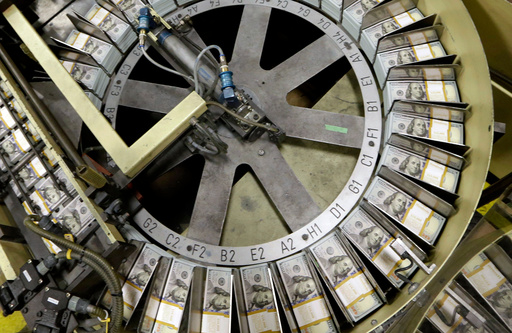 FILE - In this Sept. 24, 2013 file photo, freshly cut stacks of $100 bills make their way down the line at the Bureau of Engraving and Printing Western Currency Facility in Fort Worth, Texas. (AP Photo/LM Otero, File) FILE - In this Sept. 24, 2013 file photo, freshly cut stacks of $100 bills make their way down the line at the Bureau of Engraving and Printing Western Currency Facility in Fort Worth, Texas. (AP Photo/LM Otero, File)