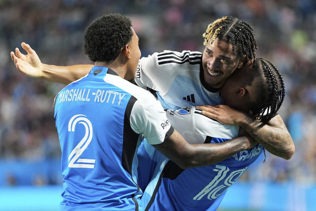Charlotte FC forward Idan Toklomati, center, celebrates his goal with defender Jahkeele Marshall-Rutty (2) and forward Kerwin Vargas (18) during the first half of an MLS soccer match against Inter Miami, Saturday, Sept. 13, 2025, in Charlotte, N.C. (AP Photo/Erik Verduzco)