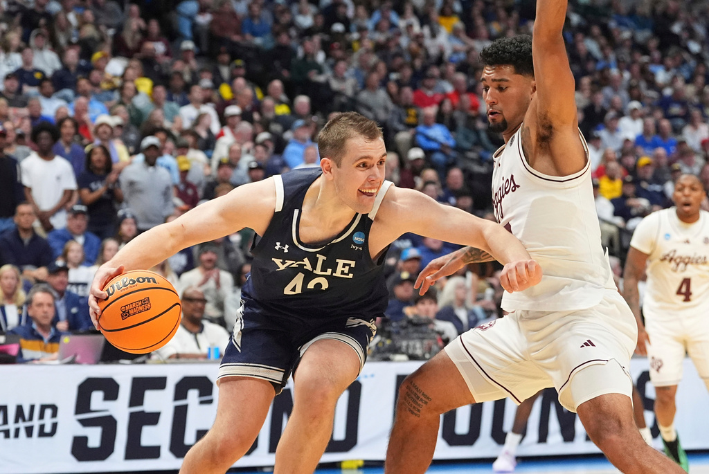 FILE - Yale forward Nick Townsend, left, drives past Texas A&M guard Jace Carter, right, during the second half in the first round of the NCAA college basketball tournament Thursday, March 20, 2025, in Denver. (AP Photo/David Zalubowski, File)