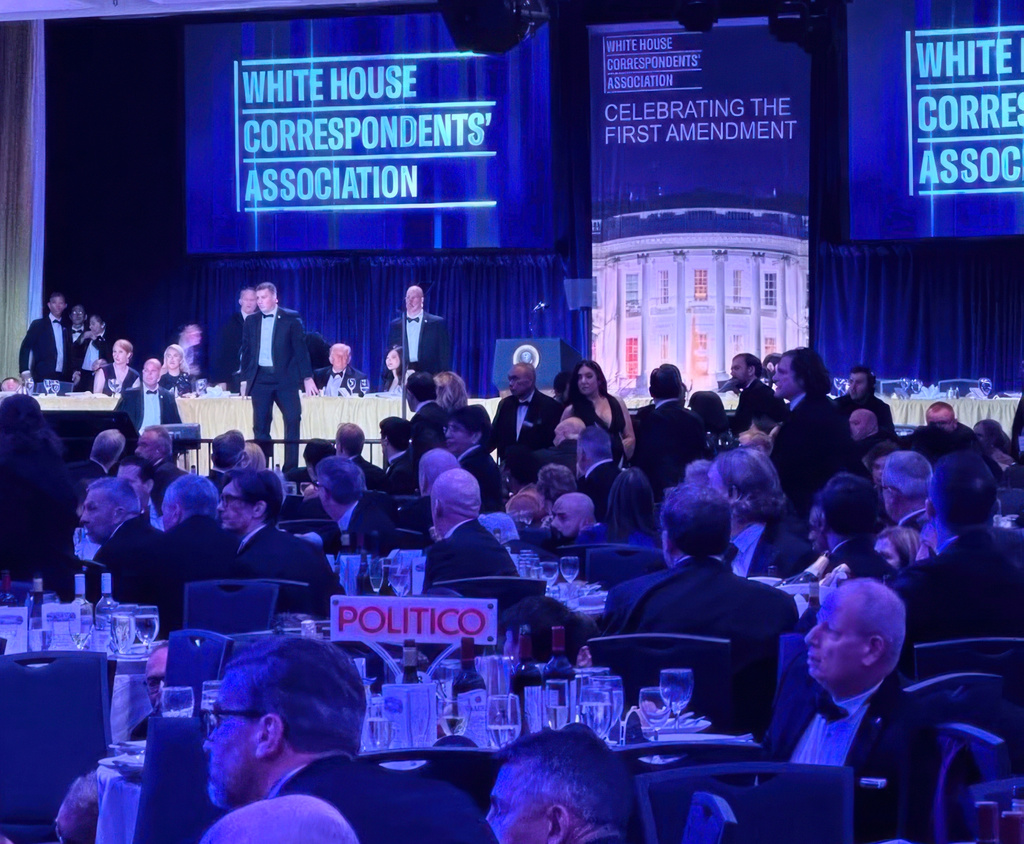 FILE - U.S. Secret Service agents respond near President Donald Trump and first lady Melania Trump during the White House Correspondents Dinner, Saturday, April 25, 2026, in Washington. (AP Photo/Alex Brandon, File)