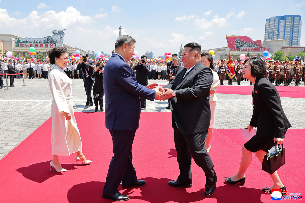 In this photo provided by the North Korean government, Chinese President Xi Jinping, center left, shakes hands with North Korean leader Kim Jong Un, center right, during a welcome ceremony in Pyongyang, Monday, June 8, 2026. Independent journalists were not given access to cover the event depicted in this image distributed by the North Korean government. The content of this image is as provided and cannot be independently verified. Korean language watermark on image as provided by source reads: "KCNA" which is the abbreviation for Korean Central News Agency. (Korean Central News Agency/Korea News Service via AP)