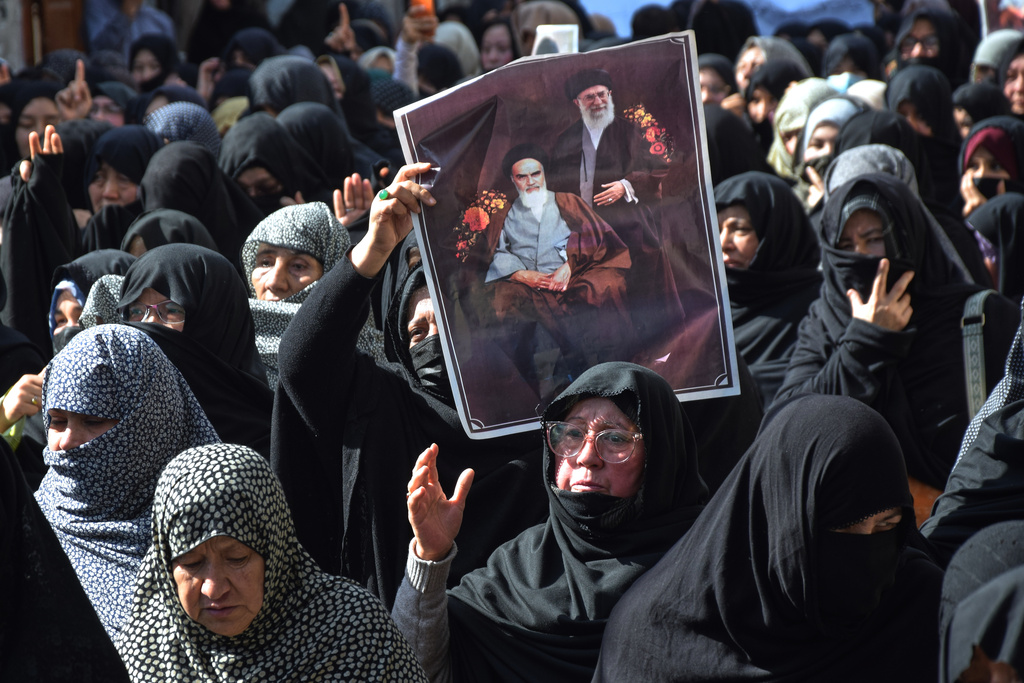 Shiite Muslims hold the portraits of Iranian leaders during a rally to condemn the killing of Iranian Supreme Leader Ayatollah Ali Khamenei, in Quetta, Pakistan, Sunday, March 1, 2026. (AP Photo/Arshad Butt)