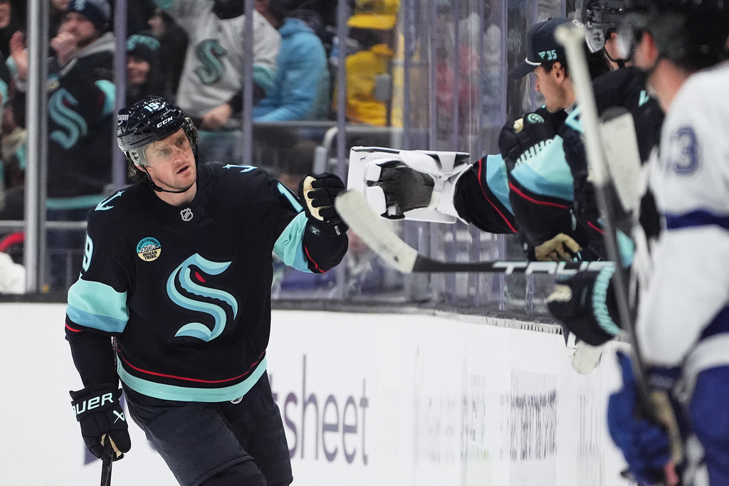 Seattle Kraken left wing Jared McCann celebrates his goal against the Tampa Bay Lightning with the bench during the second period of an NHL hockey game Tuesday, March 17, 2026, in Seattle. (AP Photo/Lindsey Wasson)