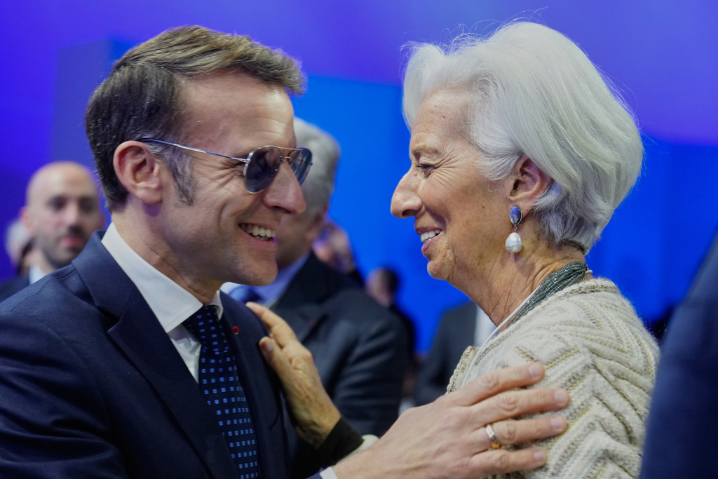 French President Emmanuel Macron talks with ECB President Christine Lagarde during the Annual Meeting of the World Economic Forum in Davos, Switzerland, Tuesday, Jan. 20, 2026. (AP Photo/Markus Schreiber)