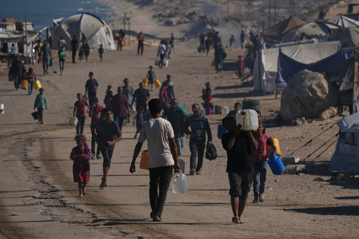Palestinians carry plastic bottles with water in an area of a makeshift tent camp for displaced people along the shore of Nuseirat, in the central Gaza Strip, Wednesday, Oct. 8, 2025. (AP Photo/Abdel Kareem Hana) Palestinians carry plastic bottles with water in an area of a makeshift tent camp for displaced people along the shore of Nuseirat, in the central Gaza Strip, Wednesday, Oct. 8, 2025. (AP Photo/Abdel Kareem Hana)