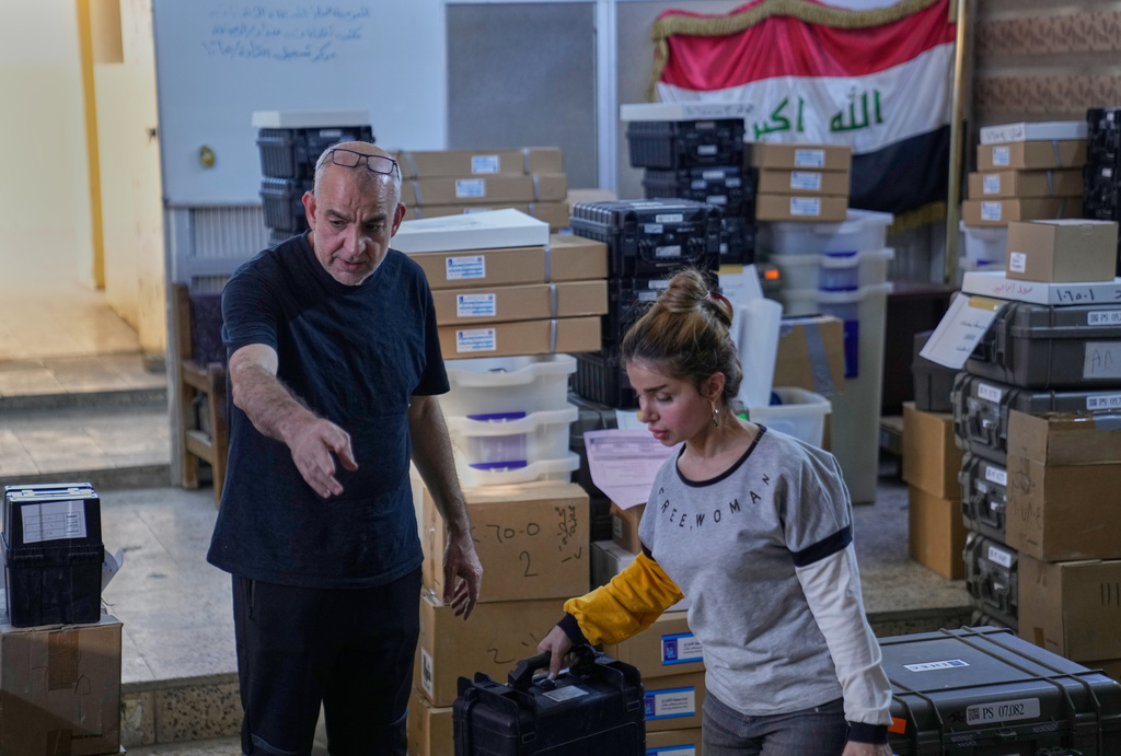 Workers from Iraq's electoral commission prepare voting materials, for the country's upcoming parliamentary elections on Nov. 11., at a polling station in Baghdad, Iraq, Thursday, Nov. 6, 2025. (AP Photo/Hadi Mizban)