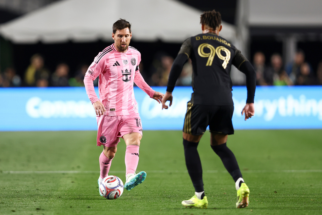 Inter Miami forward Lionel Messi, left, passes the ball Los Angeles FC forward Denis Bouanga (99) during the first half of an MLS soccer match, Saturday, Feb. 21, 2026, in Los Angeles, Calif. (AP Photo/Jessie Alcheh)