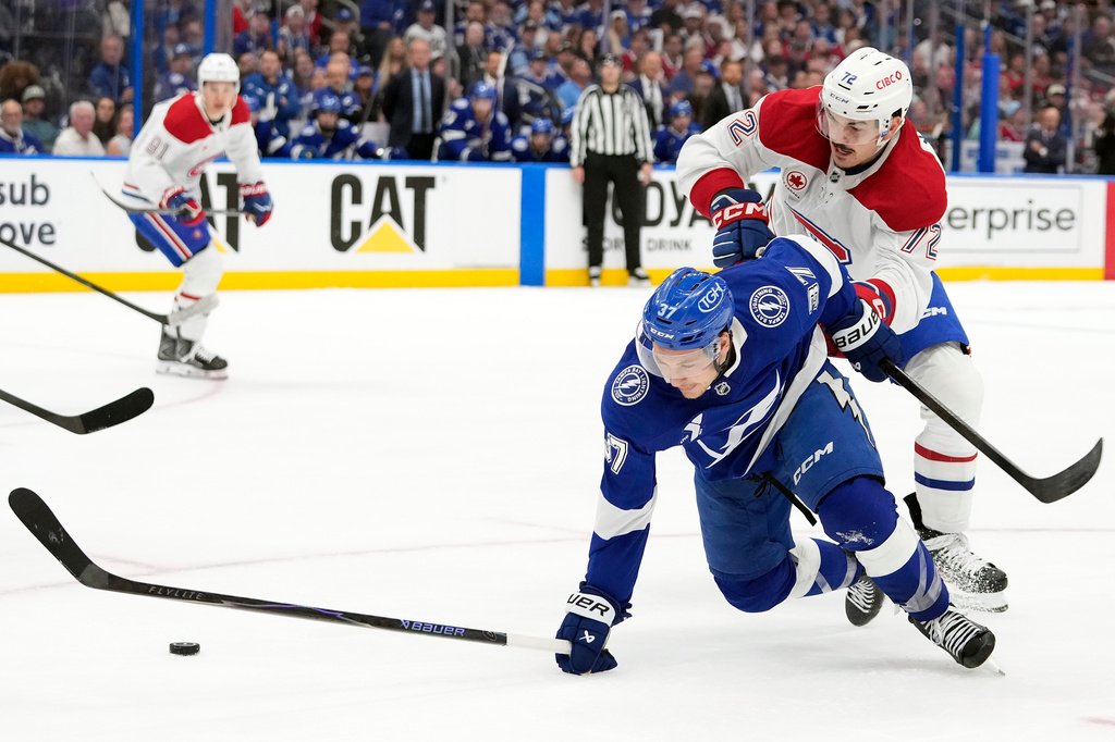 Montréal Canadiens defenseman Arber Xhekaj (72) knocks Tampa Bay Lightning center Yanni Gourde (37) off the puck during the third period in Game 1 of an NHL hockey Stanley Cup first-round playoff series, Sunday, April 19, 2026, in Tampa, Fla. (AP Photo/Chris O'Meara)