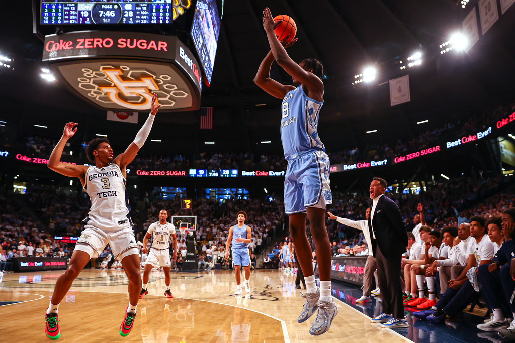 North Carolina forward Caleb Wilson, right, shoots over Georgia Tech guard Jaeden Mustaf (3) during the first half of an NCAA college basketball game, Saturday, Jan. 31, 2026, in Atlanta. (AP Photo/Colin Hubbard)