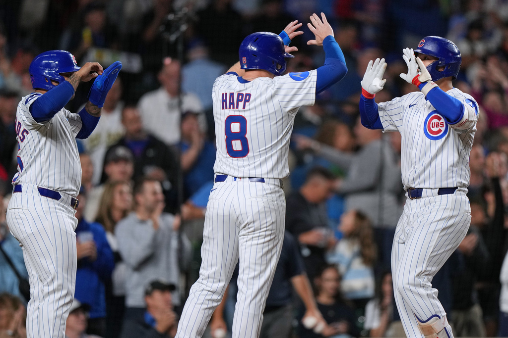 Chicago Cubs' Seiya Suzuki, right, of Japan, celebrates with Ian Happ (8) and Moisés Ballesteros after hitting a three-run home run during the sixth inning of a baseball game against the New York Mets in Chicago, Thursday, Sept. 25, 2025. (AP Photo/Nam Y. Huh)