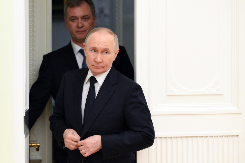 Russian President Vladimir Putin, front, enters a hall for his meeting with Hungarian Foreign Minister Peter Szijjarto at the Senate Palace of the Kremlin in Moscow, Wednesday, March 4, 2026. (Grigory Sysoyev, Sputnik, Kremlin Pool Photo via AP)