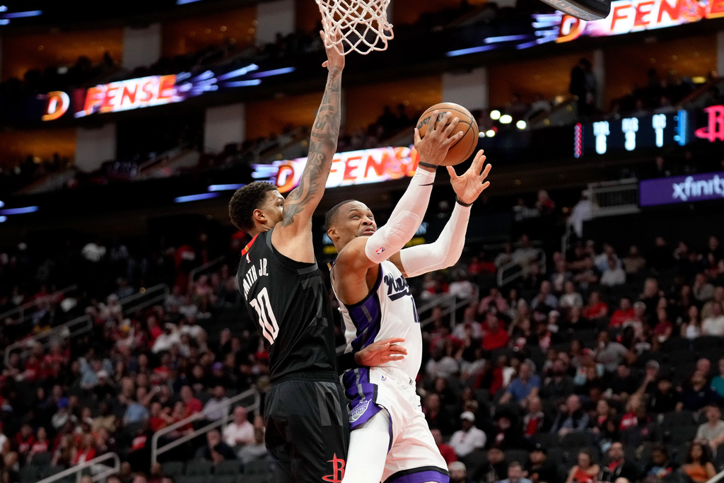 Sacramento Kings guard Russell Westbrook, right, drives to the basket as Houston Rockets forward Jabari Smith Jr. defends during the first half of an NBA basketball game, Wednesday, Feb. 25, 2026, in Houston. (AP Photo/Eric Christian Smith)