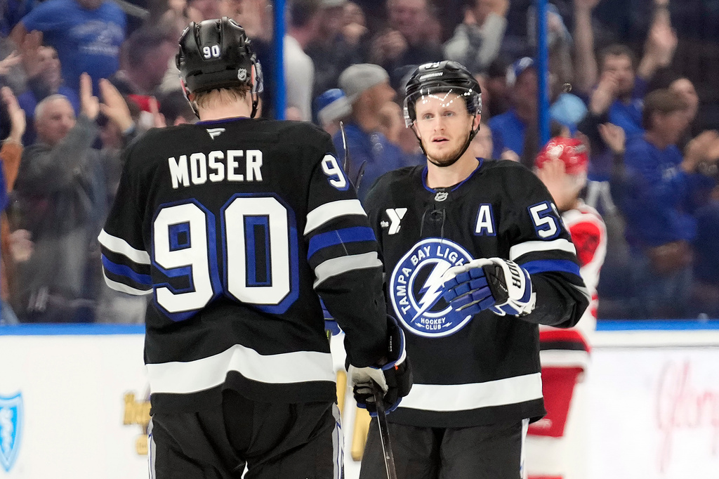 Tampa Bay Lightning center Jake Guentzel (59) celebrates his goal against the Carolina Hurricanes with defenseman J.J. Moser (90) during the third period of an NHL hockey game Saturday, Dec. 20, 2025, in Tampa, Fla. (AP Photo/Chris O'Meara)