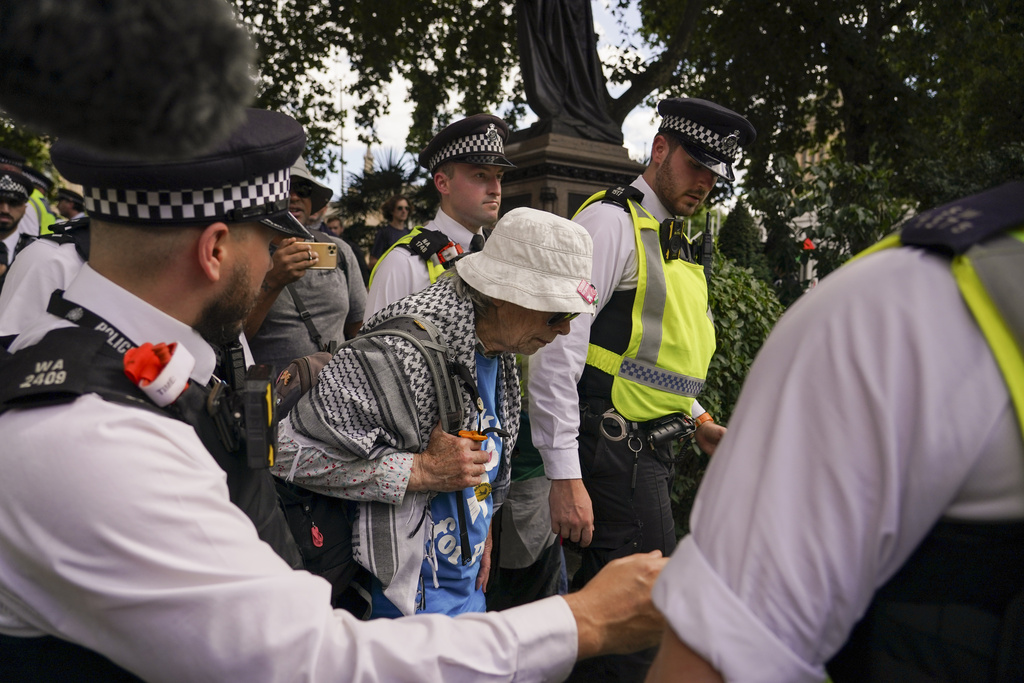 Police officers arrest a demonstrator during a protest in support of the Palestinian People in Gaza, in Parliament Square, in London, Saturday, Aug. 9, 2025.(AP Photo/Alberto Pezzali)