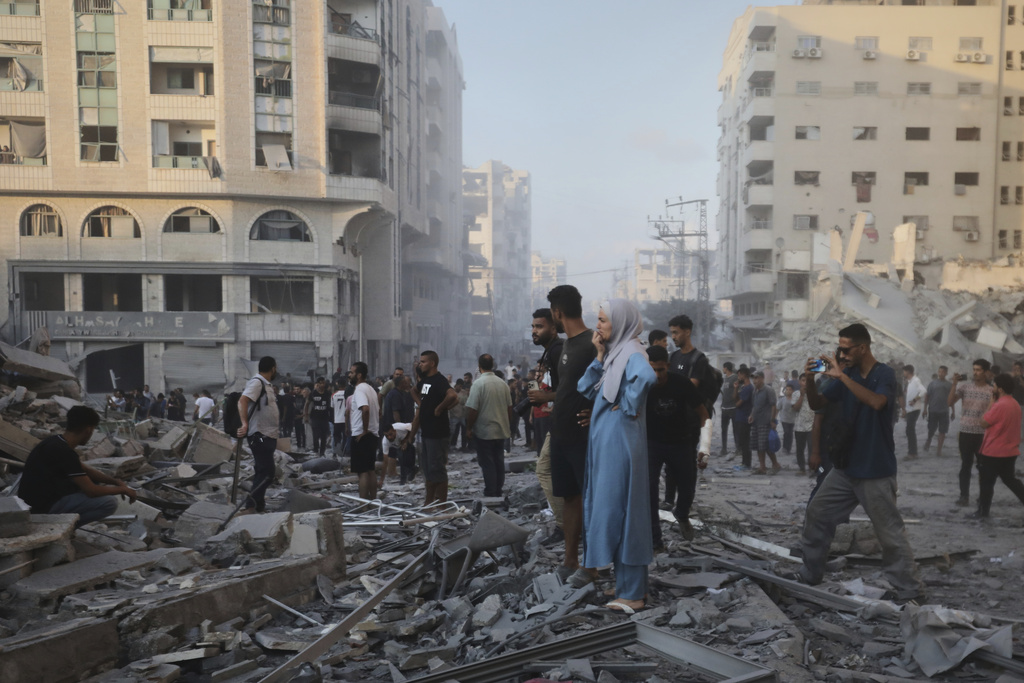 Palestinians inspect the damage after an Israeli army strike on a building in Gaza City, Sunday, Sept. 7, 2025, after the Israeli army issued a prior warning. (AP Photo/Yousef Al Zanoun)