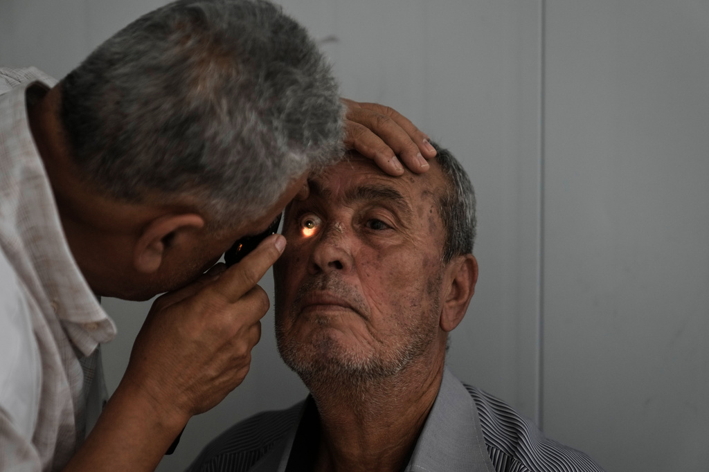 Bassam Musleh, a Palestinian patient gets his eyes checked at a mobile health clinic operated by Physicians for Human Rights Israel (PHRI) in the West Bank town of Iktaba, Tuesday, Aug. 4, 2026. (AP Photo/Majdi Mohammed)
