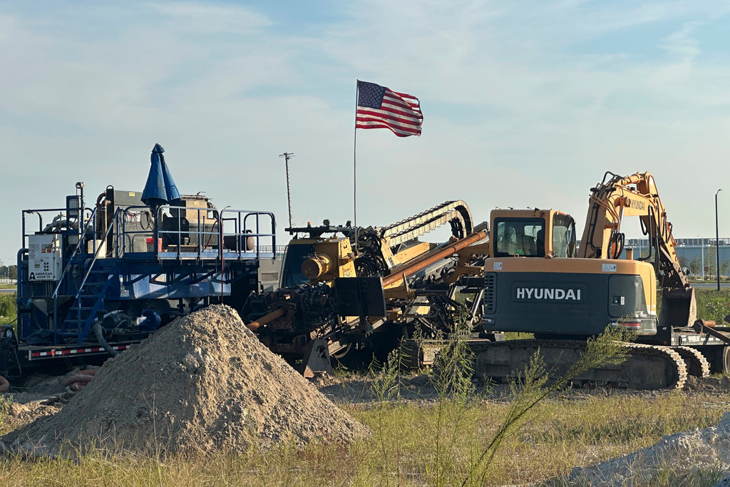 An American flag flies above a piece of heavy machinery at the site of Hyundai Motor Group's electric vehicle plant in Ellabell, Georgia, Friday, Sept. 5, 2025. (AP Photo/Russ Bynum)