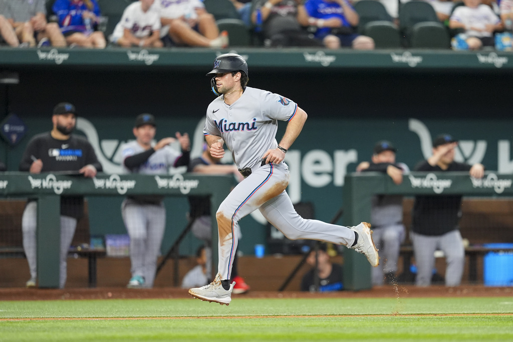 Miami Marlins' Graham Pauley scores a run off a sacrifice fly ball by teammate Brian Navarreto during the seventh inning of a baseball game against the Texas Rangers Sunday, Sept. 21, 2025, in Arlington, Texas. (AP Photo/Ronaldo Bolaños)