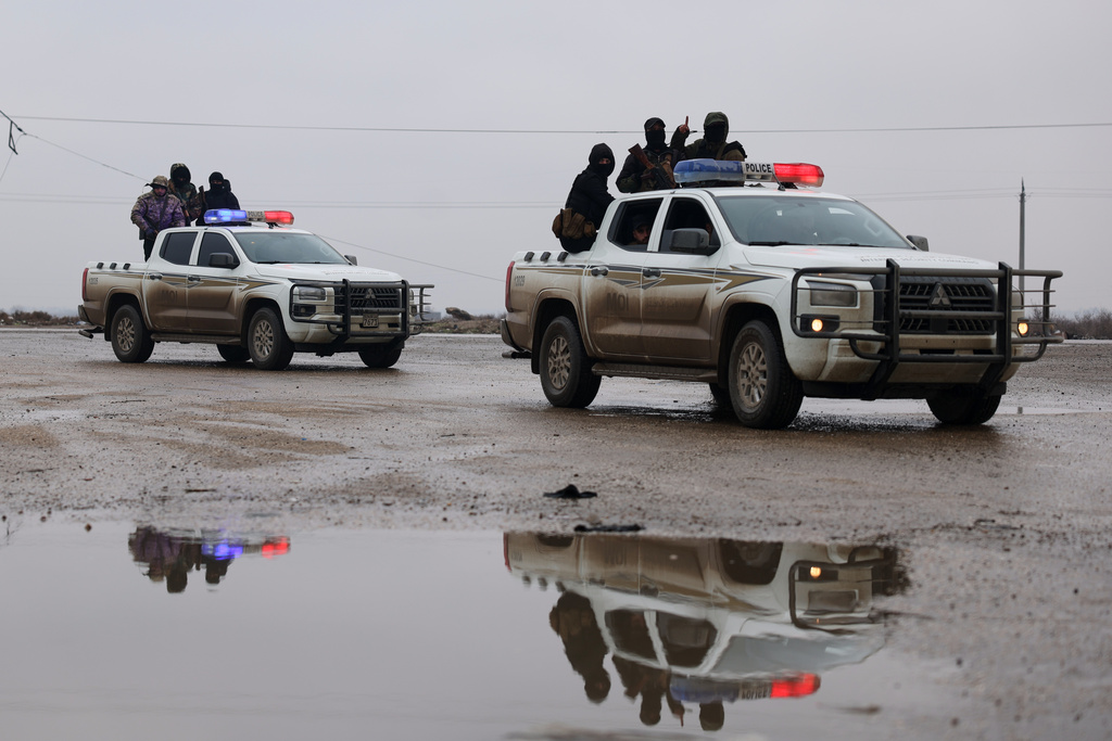 Syrian government forces drive inside the al-Aqtan prison after taking control of it from the Kurdish-led Syrian Democratic Forces, SDF, in Raqqa, northeastern Syria, Friday, Jan. 23, 2026. (AP Photo/Ghaith Alsayed)