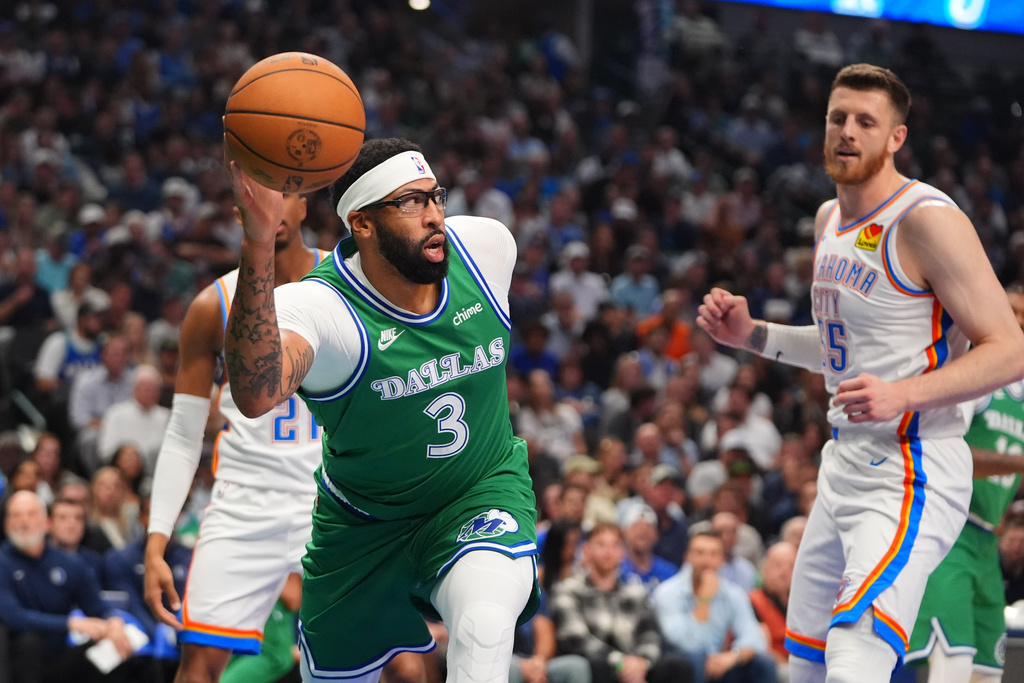 Dallas Mavericks forward Anthony Davis (3) grabs a rebound in front of Oklahoma City Thunder center Isaiah Hartenstein, right,during the first half of an NBA basketball game in Dallas, Monday, Oct. 27, 2025. (AP Photo/LM Otero)