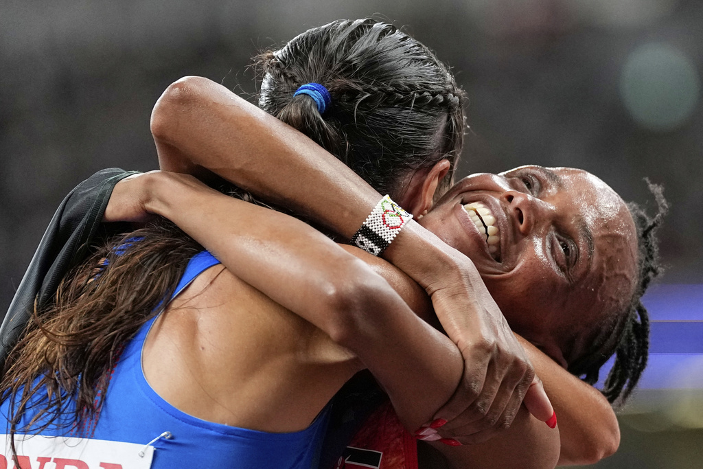 Kenya's Beatrice Chebet, gold, embraces Italy's Nadia Battocletti, silver, after winning the the women's 10,000 meters final at the World Athletics Championships in Tokyo, Saturday, Sept. 13, 2025. (AP Photo/Petr David Josek)