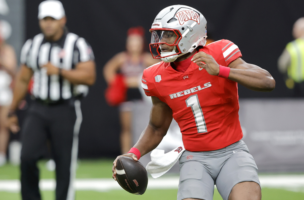 UNLV Rebels quarterback Alex Orji (1) scrambles under pressure from the Idaho State Bengals defense during the first half of an NCAA college football game Saturday, Aug. 23, 2025, in Las Vegas. (Steve Marcus/Las Vegas Sun via AP)