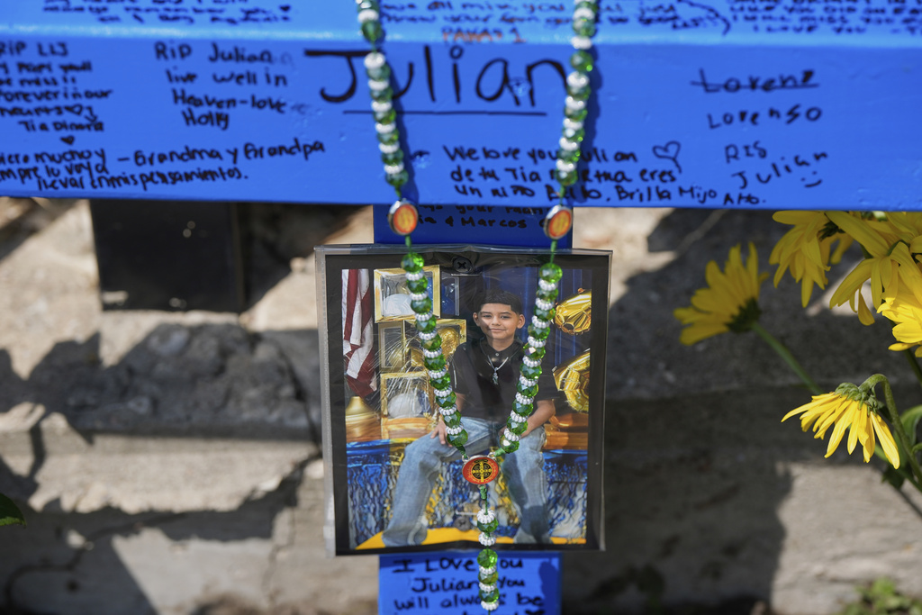 A makeshift memorial for 11-year-old Julian Guzman, who was shot and killed during a doorbell prank, is shown Tuesday, Sept. 2, 2025, in Houston. (AP Photo/David J. Phillip)