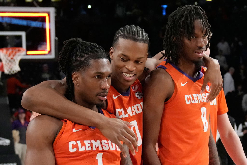 Clemson's guard Jestin Porter (1) forward RJ Godfrey (0) and forward Dallas Thomas (8) react after a win after an NCAA college basketball game against Georgia Tech, Saturday, Jan. 24, 2026, in Atlanta. (AP Photo/Brynn Anderson)
