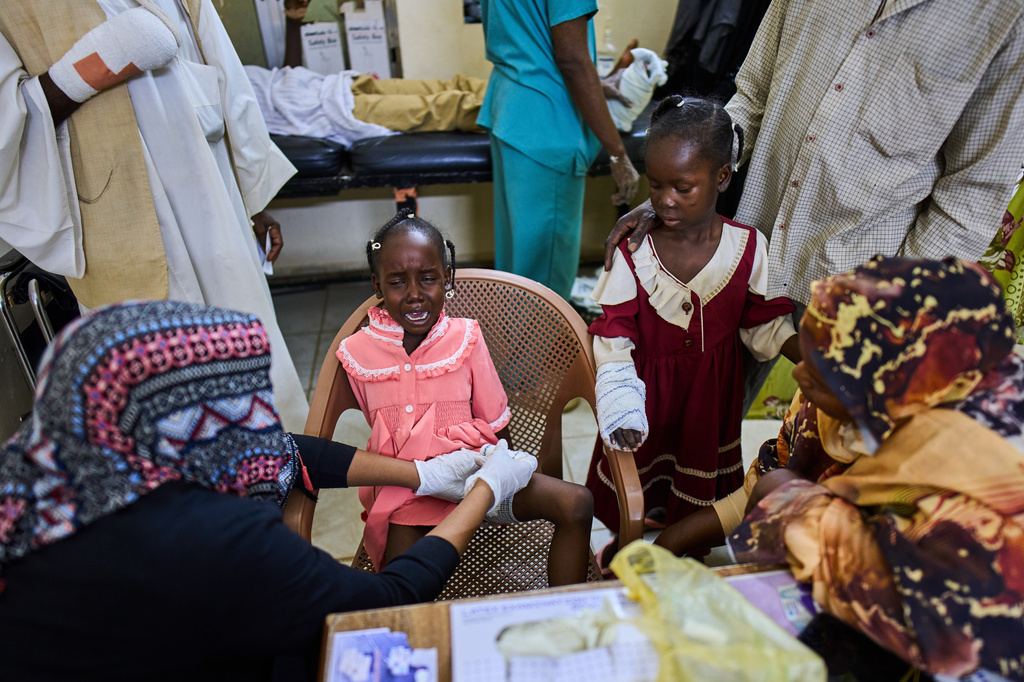 A nurse bandages a young patient injured by an unexploded ordnance blast at Al Nao Hospital in Omdurman, on the outskirts of Khartoum, Saturday, April 18, 2026. (AP Photo/Bernat Armangue)