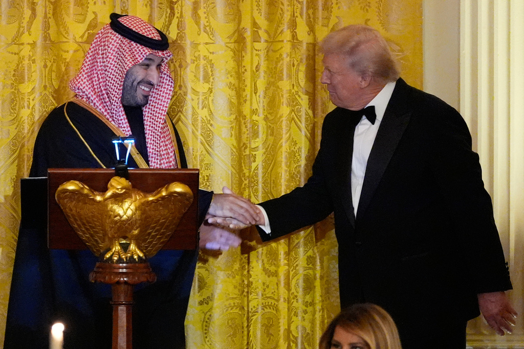 President Donald Trump and Saudi Arabia's Crown Prince Mohammed bin Salman shake hands during a dinner in the East Room of the White House, Tuesday, Nov. 18, 2025, in Washington. (AP Photo/Alex Brandon)