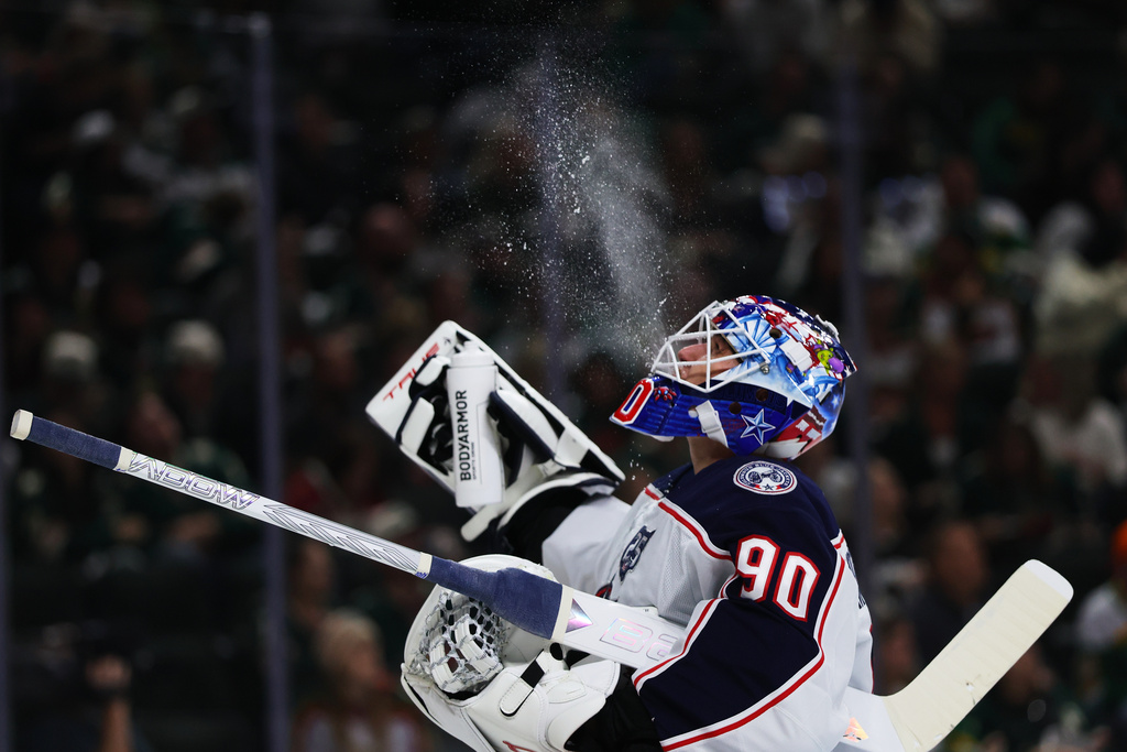 Columbus Blue Jackets goaltender Elvis Merzlikins (90) spits water before the second period of an NHL hockey game against the Minnesota Wild on Saturday, Oct. 11, 2025, in St. Paul, Minn. (AP Photo/Adam Bettcher)