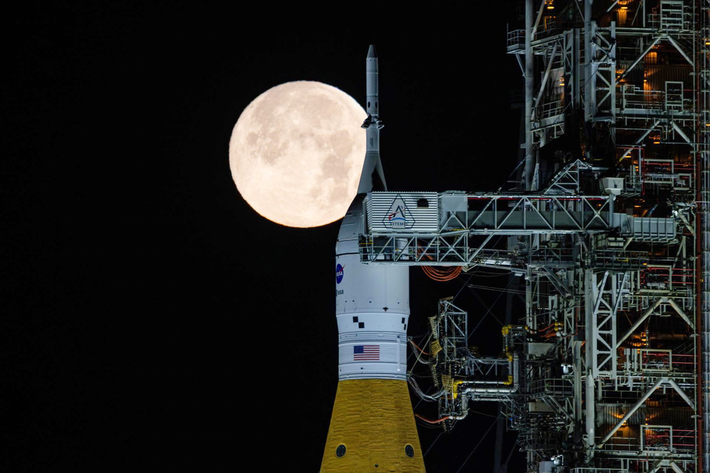 FILE - A full moon is seen shining over NASA's SLS (Space Launch System) and Orion spacecraft atop the mobile launcher in the early hours of Feb. 1, 2026, at NASA's Kennedy Space Center in Florida. (Sam Lott/NASA via AP, File)