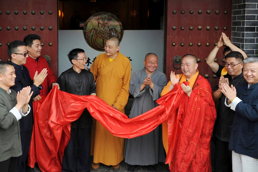 FILE - Shi Yongxin, third from right in yellow and red robes, abbot of the Shaolin Temple, attends the opening ceremony of an urban zen center named Shaolin Chan Hall in Xi'an in northwest China's Shaanxi province on Sunday June 28, 2015. (Chinatopix via AP, file)
