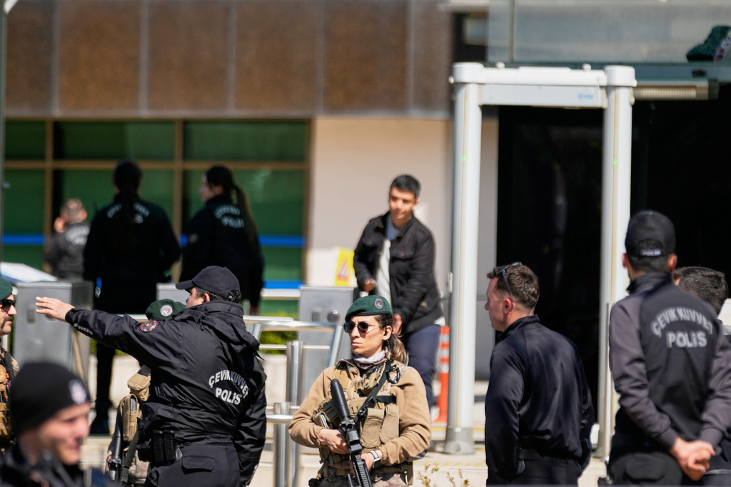 Turkish police and army secure the area after a gunmen attack at a building housing the Israeli Consulate in Istanbul, Turkey, Tuesday, April 7, 2026. (AP Photo/Khalil Hamra)