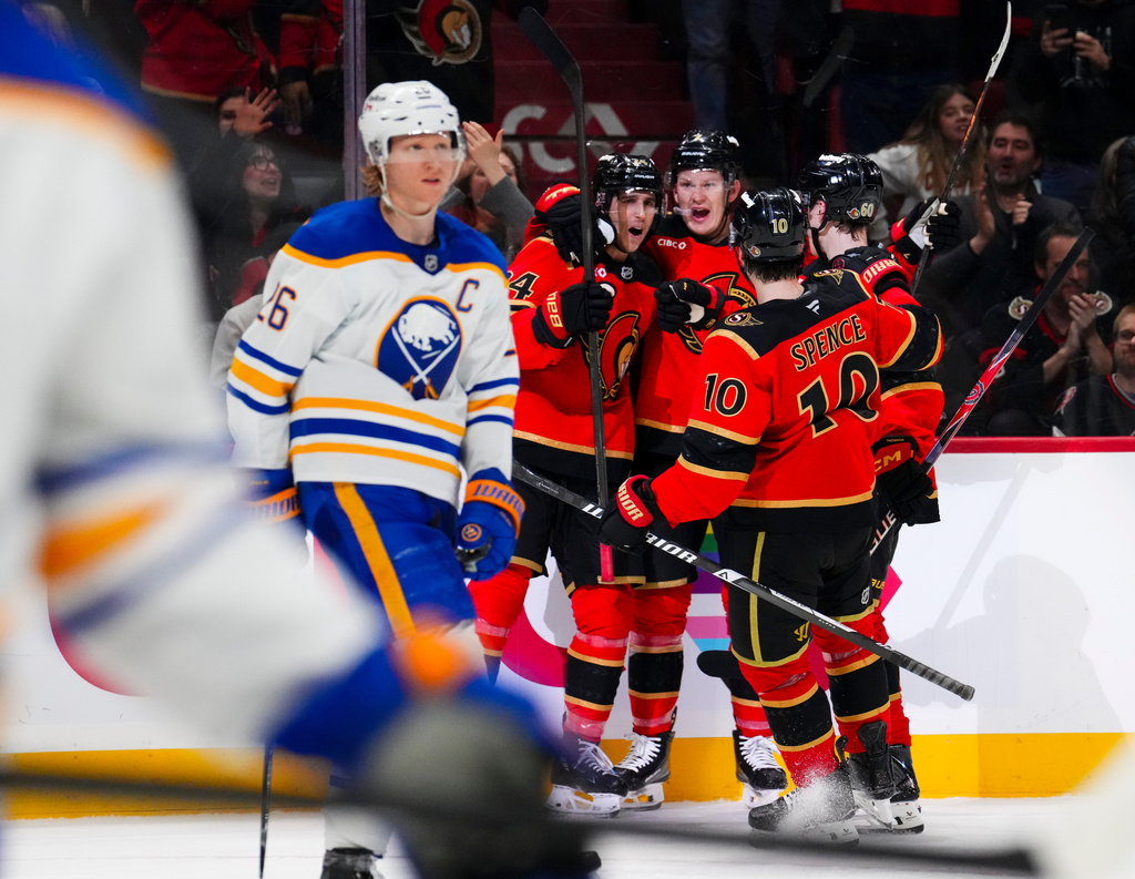 Ottawa Senators' Dylan Cozens, third from right, celebrates with teammates after scoring as Buffalo Sabres' Rasmus Dahlin (26) skates past during second-period NHL hockey game action in Ottawa, Ontario, Thursday, April 2, 2026. (Sean Kilpatrick/The Canadian Press via AP)