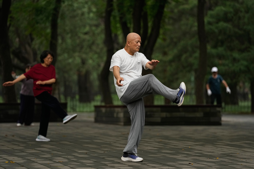People practice Tai Chi at a park near the Temple of Heaven in Beijing, Thursday July 9, 2026. (AP Photo/Andy Wong)