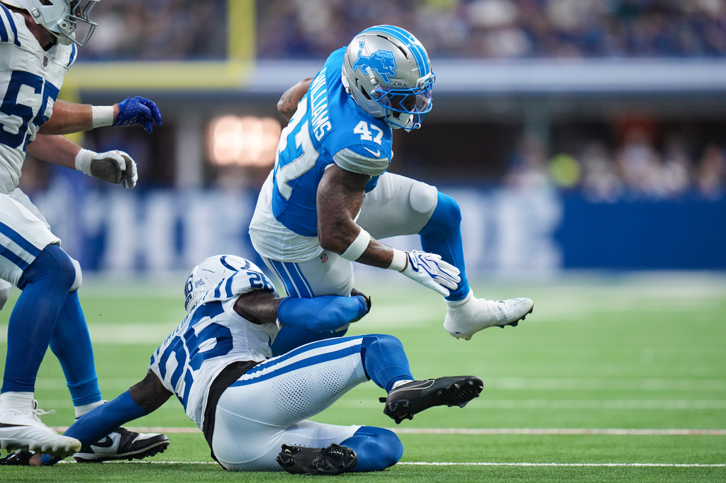 Detroit Lions running back Trayveon Williams (47) is tackled by Indianapolis Colts cornerback Cam Taylor-Britt (26) during the first half of a preseason NFL football game in Indianapolis, Saturday, Aug. 29, 2026. (AP Photo/Jeff Roberson)
