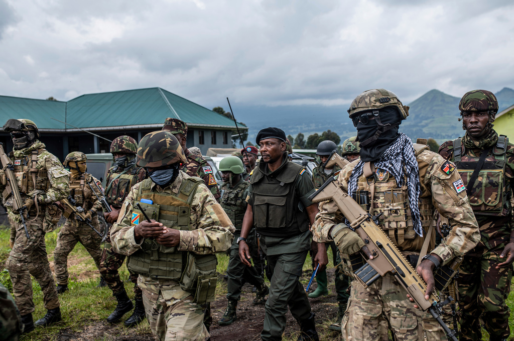 FILE - Surrounded by members of the Kenya Defence Forces (KDF), Willy Ngoma, spokesman of the M23, center, arrives for a ceremony to mark the withdrawal from their positions in the town of Kibumba, in the eastern of Democratic Republic of Congo, Friday, Dec. 23, 2022. (AP Photo/Moses Sawasawa, File)