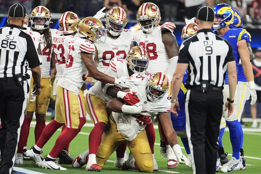 San Francisco 49ers defensive tackle Alfred Collins, bottom, celebrates with teammates after recovering a fumble against the Los Angeles Rams during the second half of an NFL football game, Thursday, Oct. 2, 2025, in Inglewood, Calif. (AP Photo/Marcio Jose Sanchez)