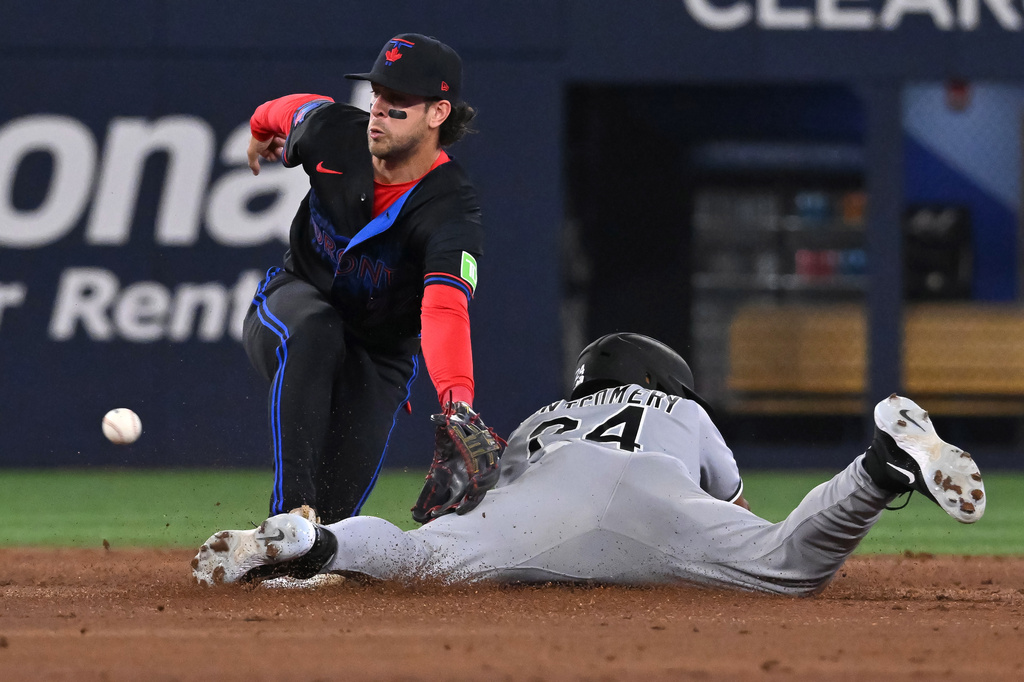 Chicago White Sox' Braden Montgomery (24) slides safely into second with a stolen base ahead of a tag by Toronto Blue Jays infielder Ernie Clement (22) during the second inning of a baseball game in Toronto on Friday, July 17, 2026. (Jon Blacker/The Canadian Press via AP)