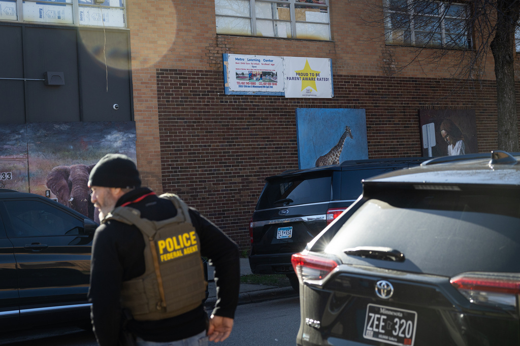 A federal police officer stands outside the Metro Learning Center in Minneapolis as federal agents execute a search warrant, Tuesday, April 28, 2026. (Ben Hovland/Minnesota Public Radio via AP)