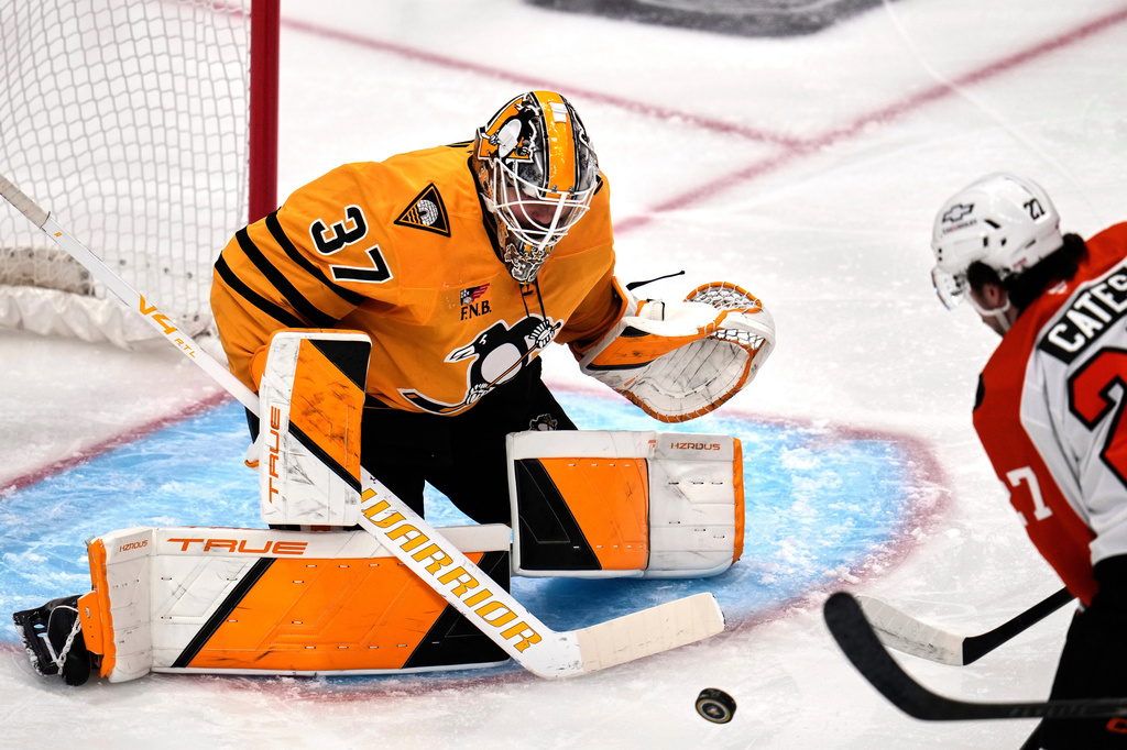 Pittsburgh Penguins goaltender Arturs Silovs (37) blocks a shot by Philadelphia Flyers' Noah Cates (27) during the first period of Game 5 in the first round of an NHL hockey Stanley Cup playoff series in Pittsburgh, Monday, April 27, 2026. (AP Photo/Gene J. Puskar)