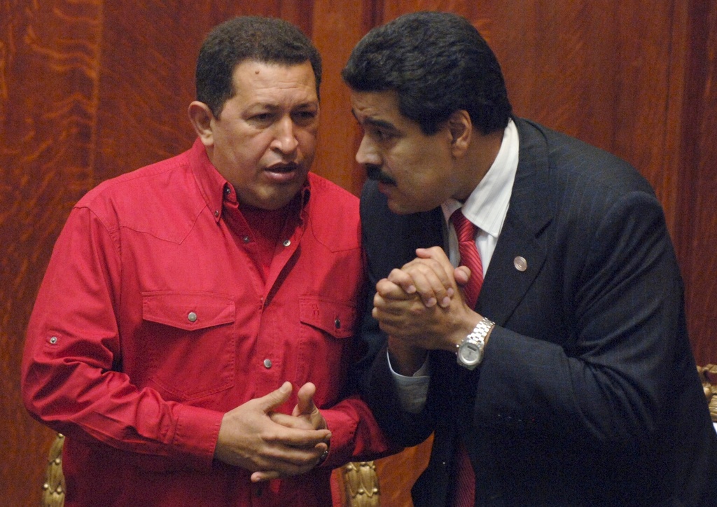 FILE - Venezuela's President Hugo Chavez, left, talks to then Foreign Minister Nicolas Maduro in Montevideo, Uruguay, Dec. 18, 2007. (AP Photo/Matilde Campodonico, File)